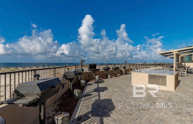 view of patio / terrace with a water view, area for grilling, and grilling area