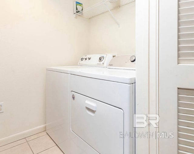 washroom with separate washer and dryer and light tile patterned floors