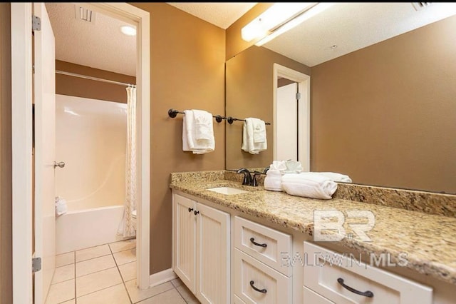 bathroom featuring shower / tub combo with curtain, tile patterned floors, a textured ceiling, and vanity