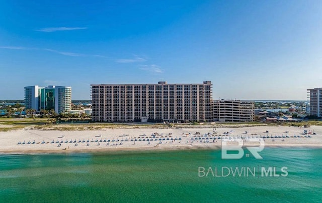 birds eye view of property featuring a water view and a beach view