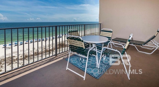 balcony featuring a water view and a view of the beach