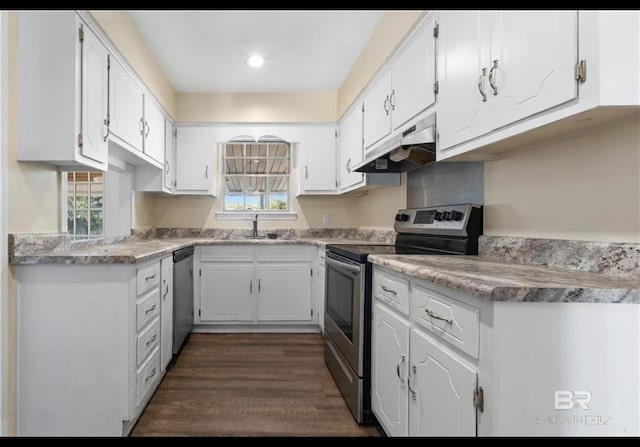 kitchen featuring stainless steel appliances, white cabinets, a sink, and under cabinet range hood