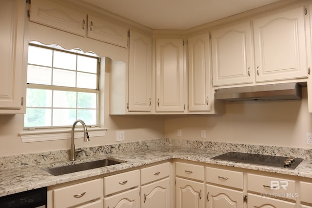kitchen with black electric cooktop, a sink, dishwashing machine, under cabinet range hood, and white cabinetry