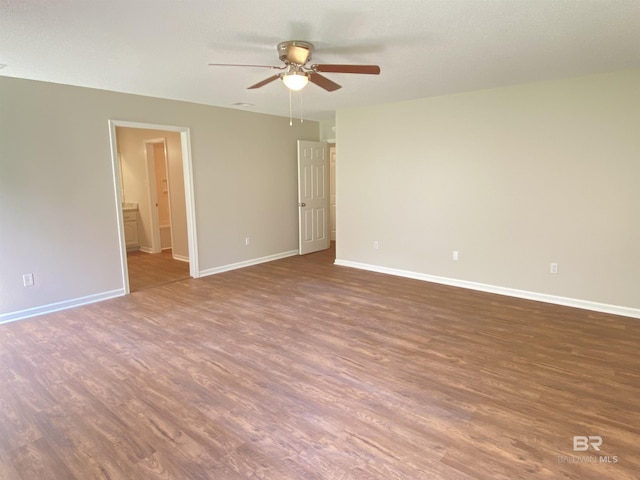 unfurnished room featuring baseboards, a ceiling fan, and wood finished floors