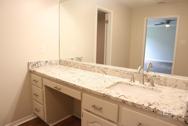 bathroom with vanity, ceiling fan, baseboards, and visible vents