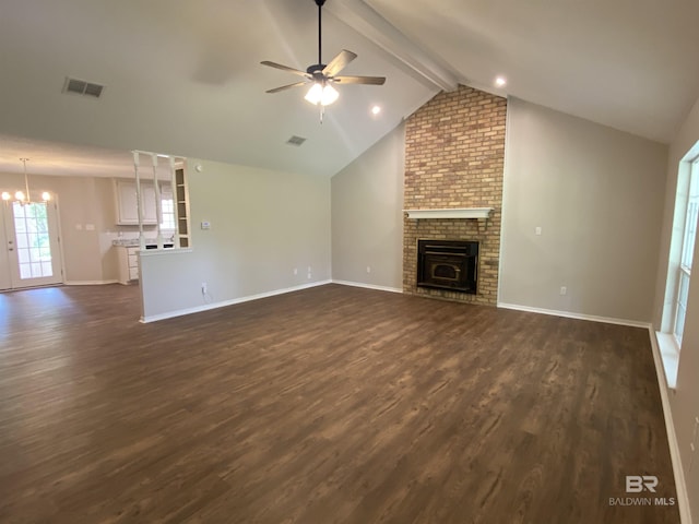 unfurnished living room featuring visible vents, dark wood-style flooring, a brick fireplace, baseboards, and ceiling fan with notable chandelier