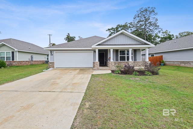 craftsman inspired home featuring a porch, a front yard, and a garage