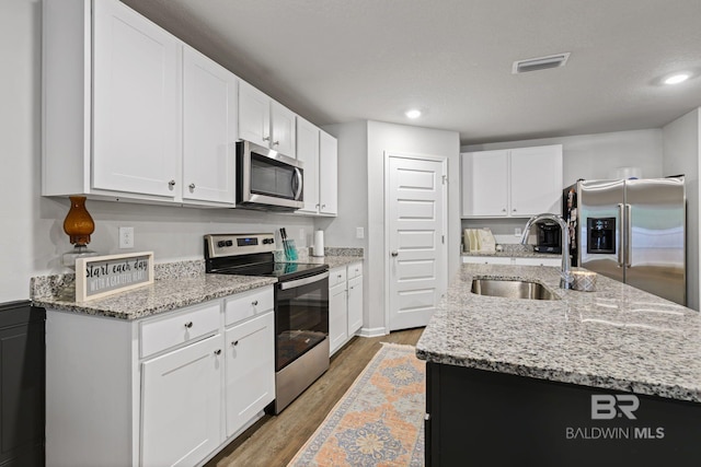 kitchen featuring appliances with stainless steel finishes and white cabinetry