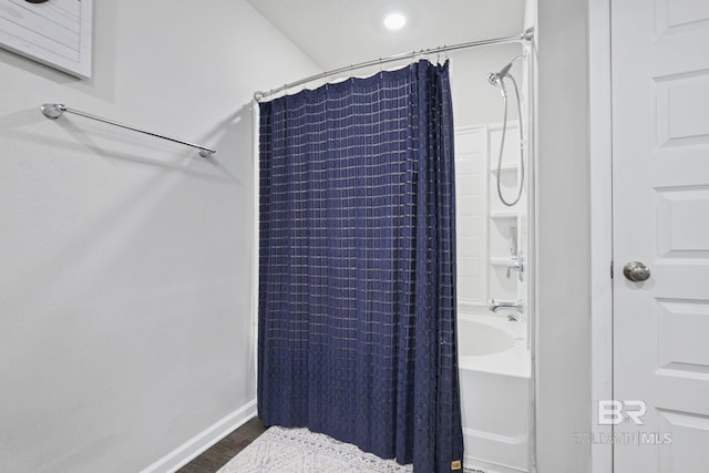 bathroom with shower / bathtub combination with curtain and wood-type flooring