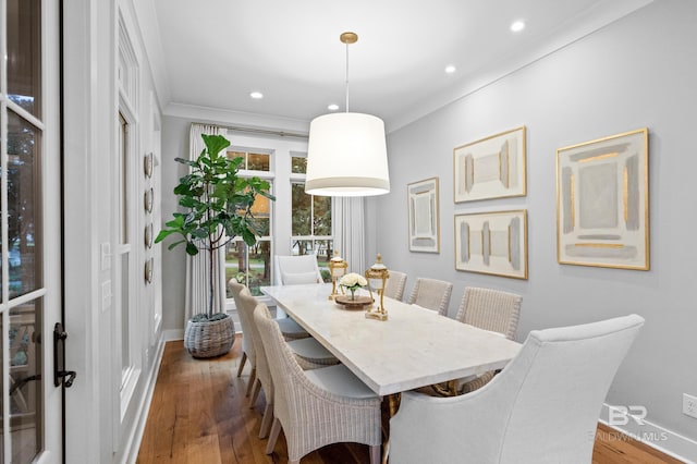 dining space with dark hardwood / wood-style flooring, ornamental molding, and french doors