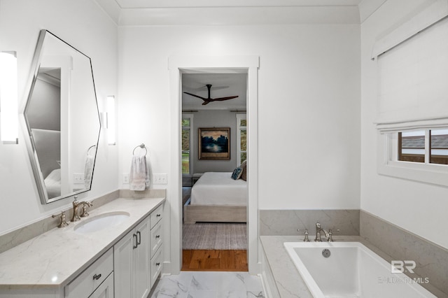 bathroom with vanity, ceiling fan, and a tub