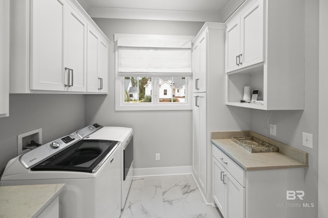 laundry area with washer and clothes dryer and cabinets