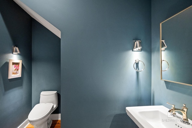 bathroom featuring sink and toilet