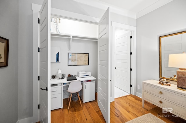 office space featuring crown molding and light hardwood / wood-style flooring