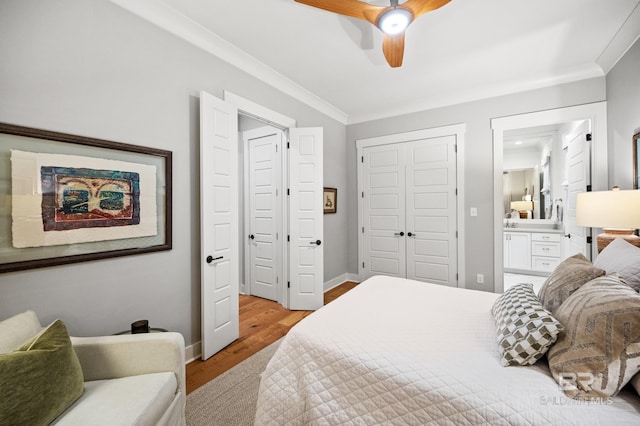 bedroom featuring a closet, ceiling fan, light hardwood / wood-style flooring, and crown molding