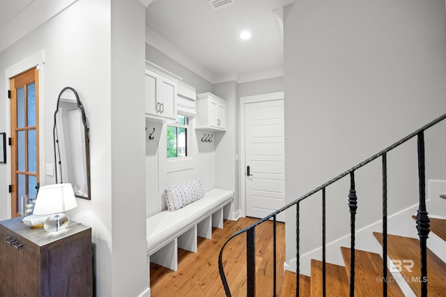 mudroom with light hardwood / wood-style flooring and ornamental molding