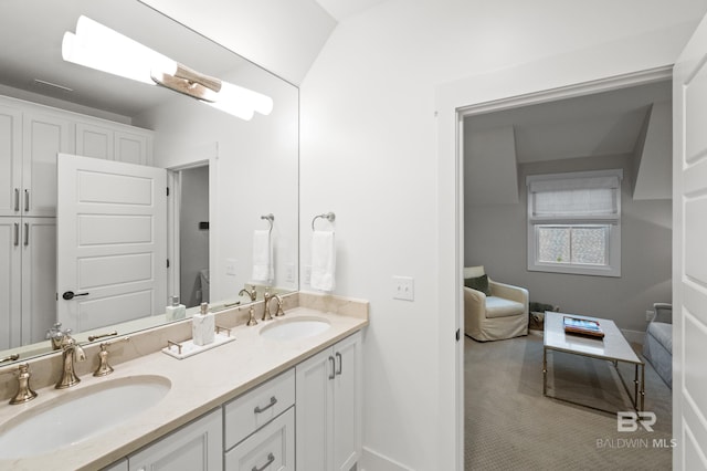 bathroom featuring vanity and vaulted ceiling