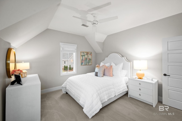 bedroom with ceiling fan, light colored carpet, and vaulted ceiling