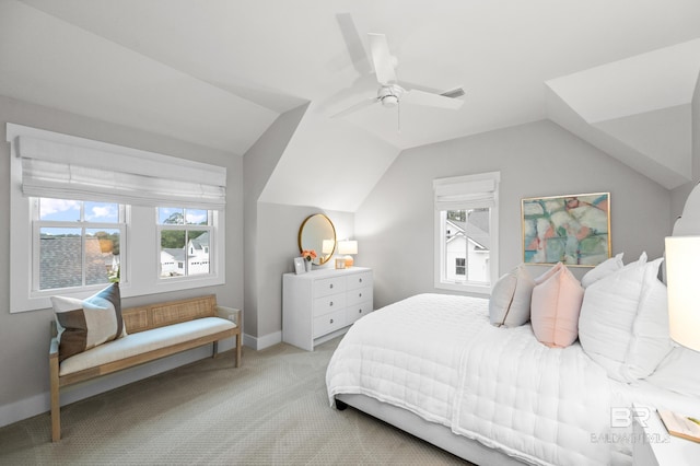 bedroom with ceiling fan, lofted ceiling, and light carpet