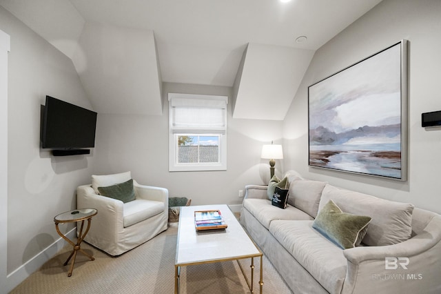 living room featuring lofted ceiling and carpet floors