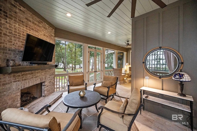 living room featuring exterior fireplace and lofted ceiling