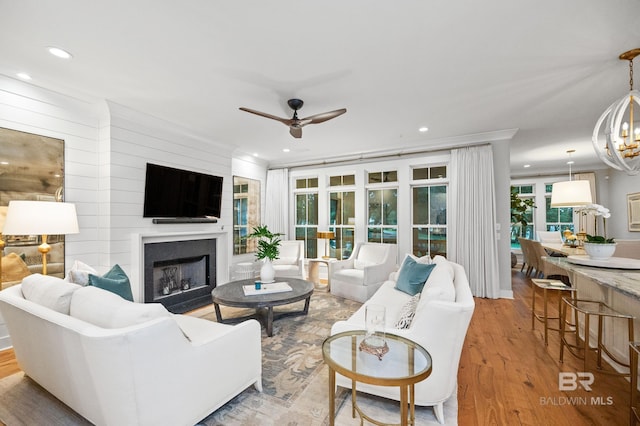 living room featuring light hardwood / wood-style flooring and ceiling fan