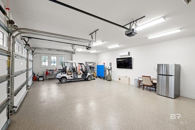 garage featuring stainless steel fridge and a garage door opener