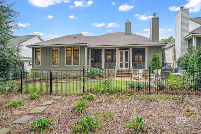 back of house with a sunroom