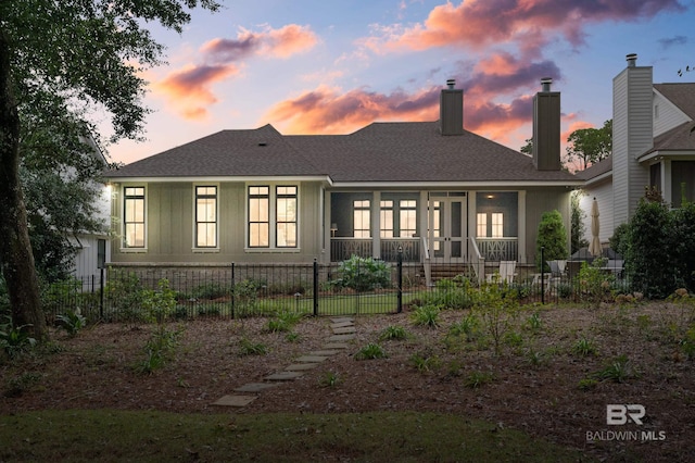 view of back house at dusk