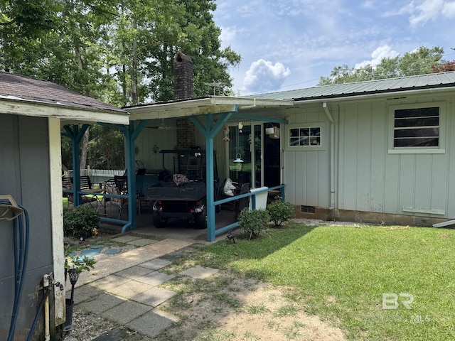 15760 Pine Grove Rd Extension, Bay Minette, AL 36507 - rear view of house featuring a yard, a chimney, metal roof, and crawl space