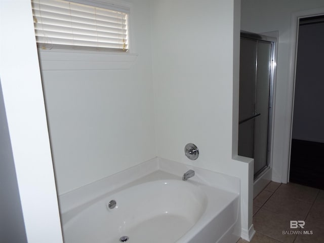 bathroom with tile patterned floors and plus walk in shower