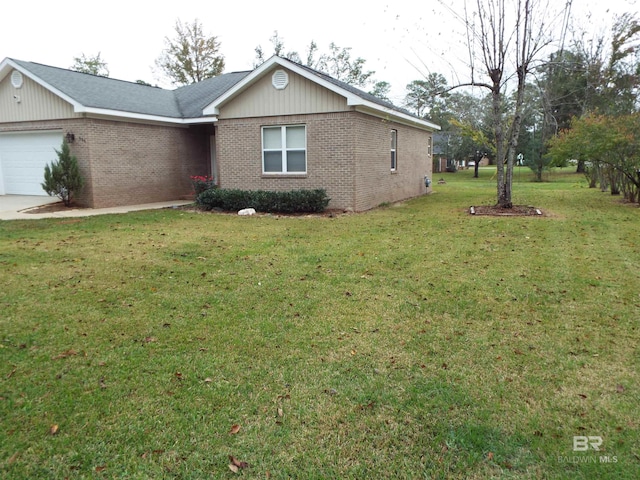 view of side of property featuring a yard and a garage