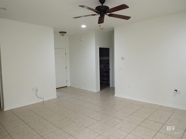 spare room featuring ceiling fan and light tile patterned floors