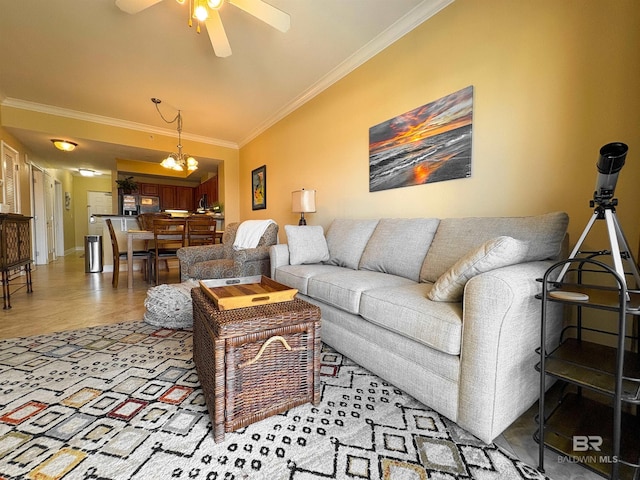 living area featuring baseboards, ornamental molding, wood finished floors, and ceiling fan with notable chandelier