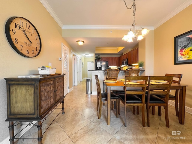 dining room featuring crown molding, baseboards, and a notable chandelier