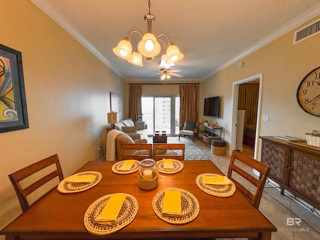 dining space with crown molding, visible vents, light tile patterned floors, and ceiling fan with notable chandelier