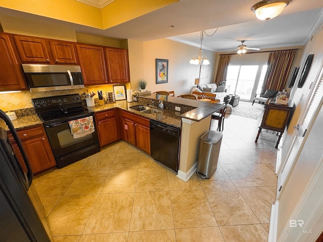 kitchen with a sink, a peninsula, open floor plan, ornamental molding, and black appliances