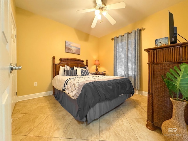 bedroom with light tile patterned floors, baseboards, and ceiling fan