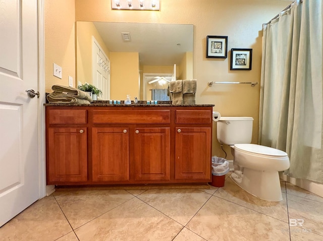 bathroom featuring ceiling fan, tile patterned flooring, vanity, toilet, and curtained shower