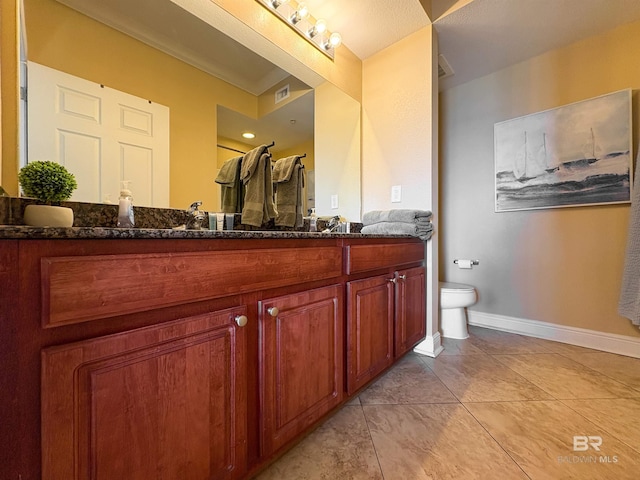 bathroom featuring toilet, baseboards, visible vents, and vanity