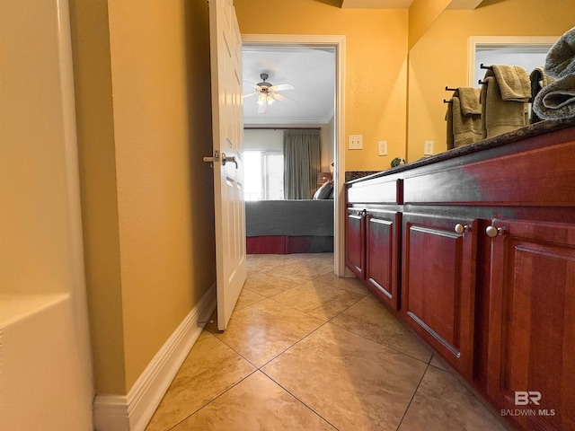 bathroom featuring baseboards, ornamental molding, ceiling fan, and tile patterned floors
