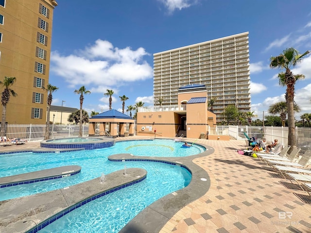 pool featuring a gazebo, a hot tub, fence, and a patio area