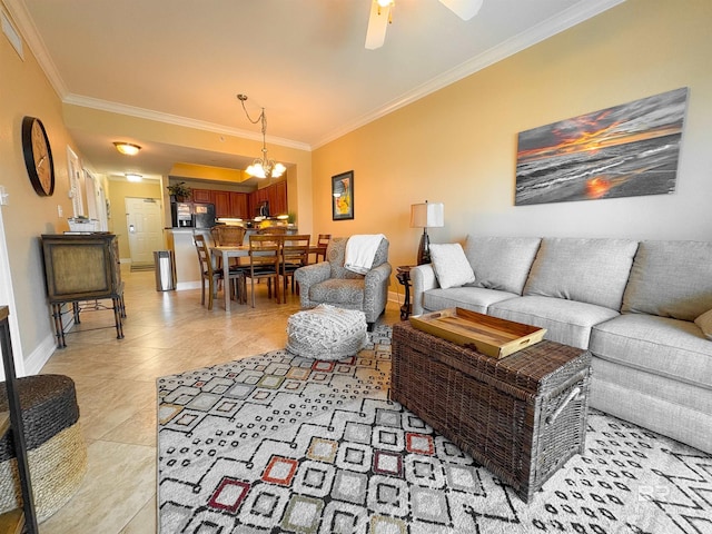 living area with ceiling fan with notable chandelier, baseboards, light tile patterned floors, visible vents, and ornamental molding