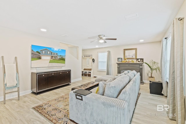 living room featuring ceiling fan and light wood-type flooring