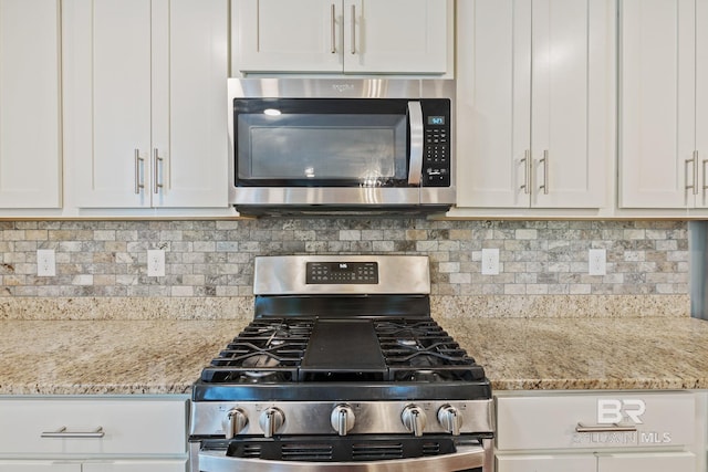 kitchen featuring appliances with stainless steel finishes and white cabinetry