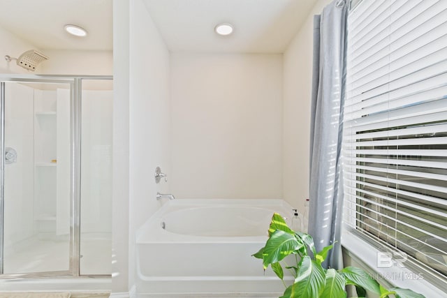 bathroom with shower with separate bathtub