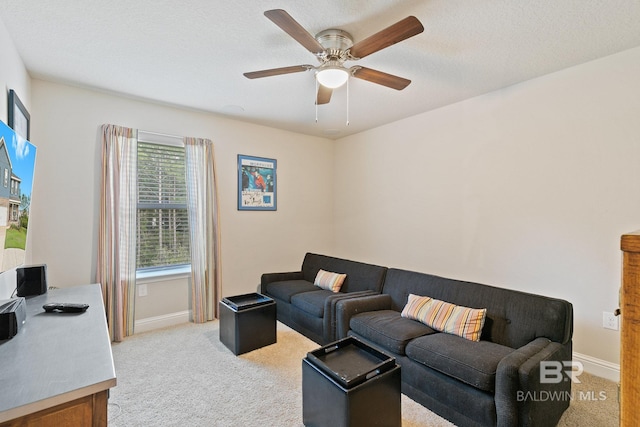 living room featuring ceiling fan, light colored carpet, and a textured ceiling