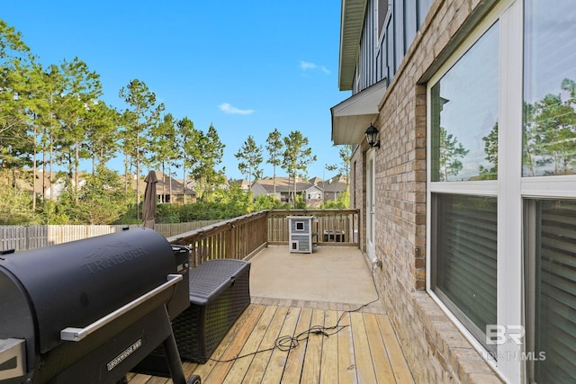 wooden terrace featuring a grill