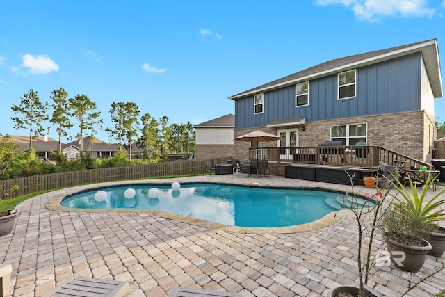 view of pool featuring a deck and a patio area