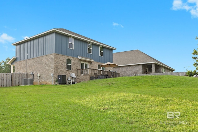 back of house featuring cooling unit and a yard